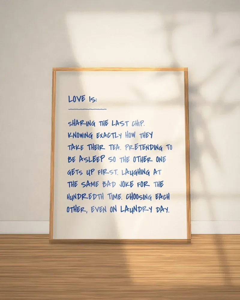 Hand-lettered Love Is quote print in a wooden frame